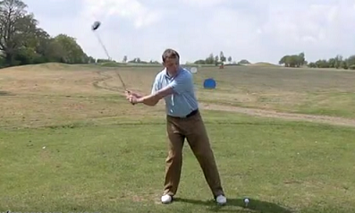 Image showing golfer swaying away from the ball during the backswing